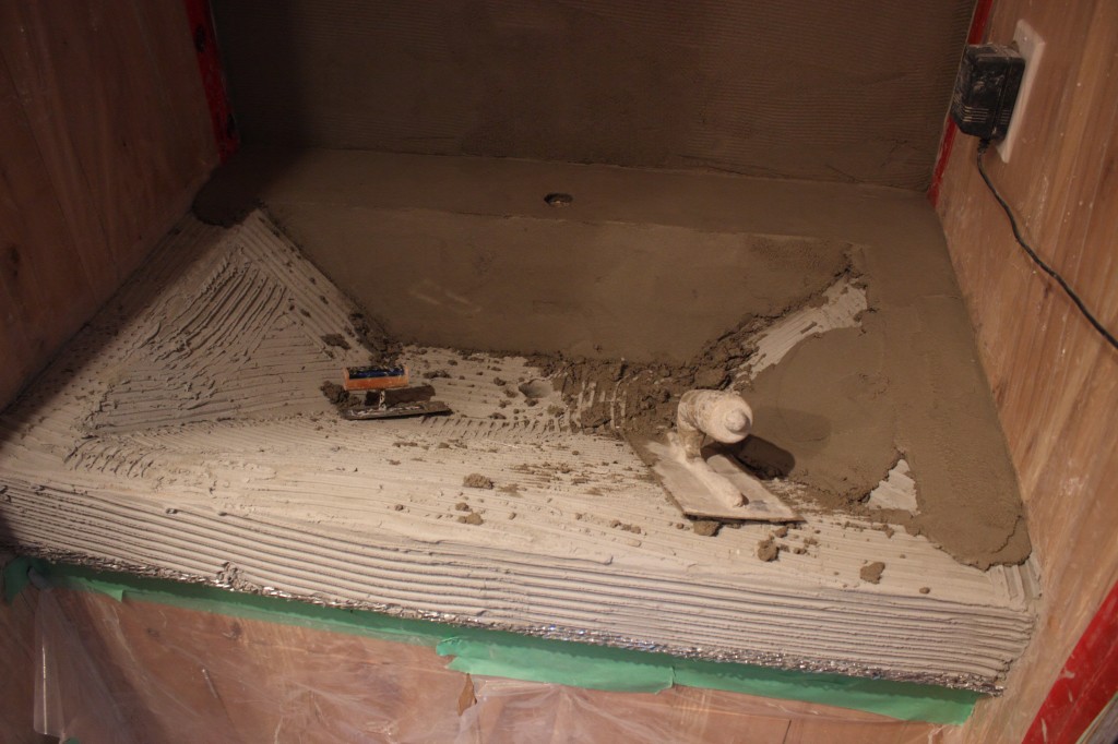 A layer of thinset is followed up by 1/2" of cement-lime